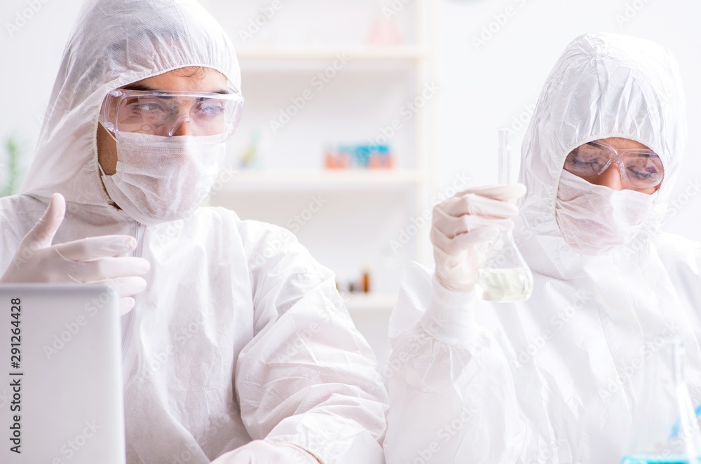 Two chemists working in the lab Two chemists working in the lab