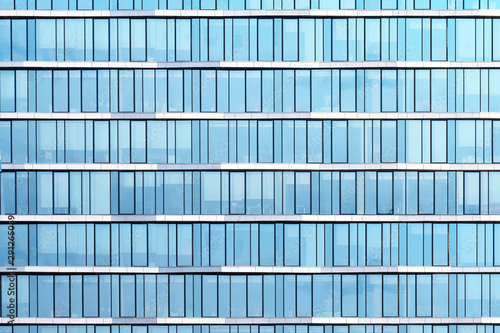 Glass windows of office building, construction background. Blue tones Glass windows of office building, construction background. Blue tones