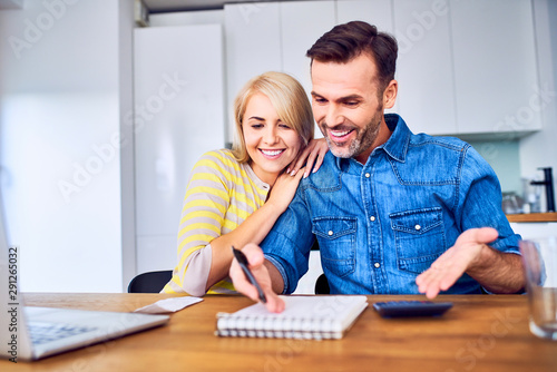 Happy couple managing home finances