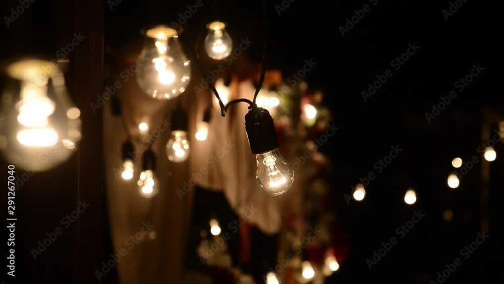Lamps close up. Wedding garlands that glow on the arch. Vespers Wedding Ceremony Lamps close up. Wedding garlands that glow on the arch. Vespers Wedding Ceremony
