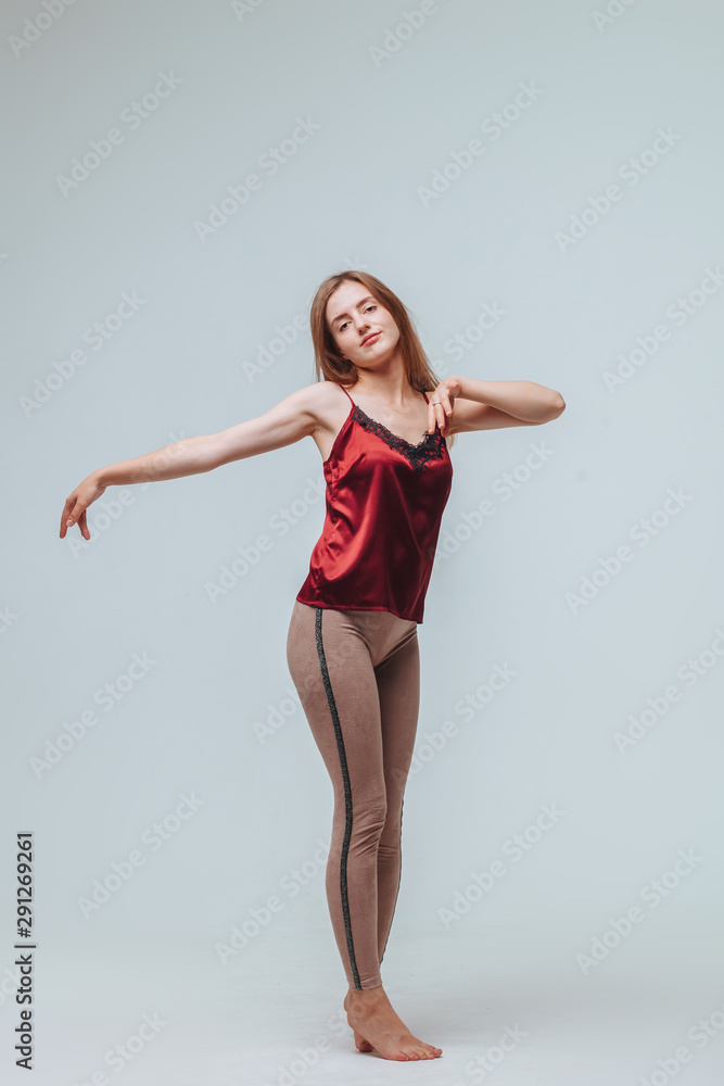 Girl in leggings and blouse on grey background Girl in leggings and blouse on grey background