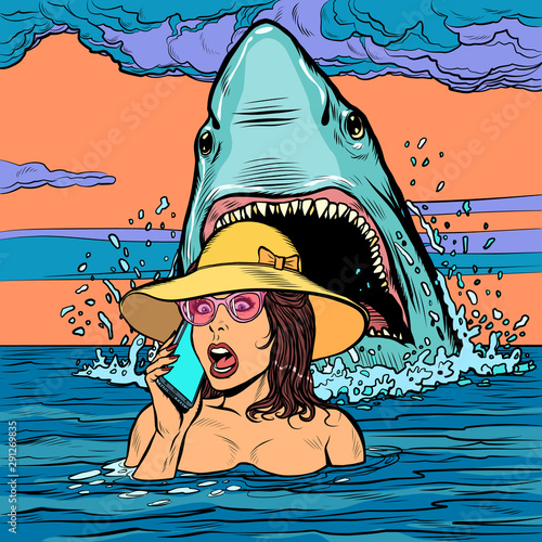 A shark attacks a woman at sea. The girl asks for help on the phone