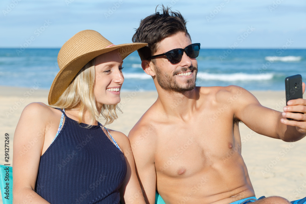 couple in love makes selfie beach