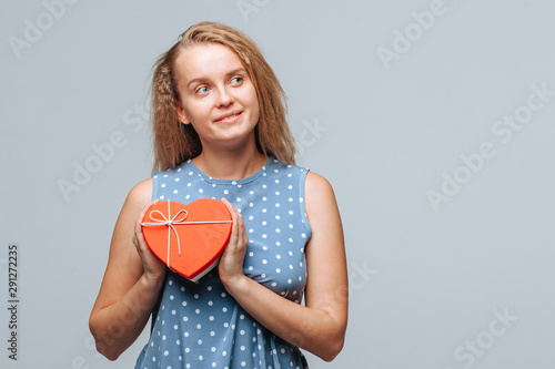 Girl holding heart gift box