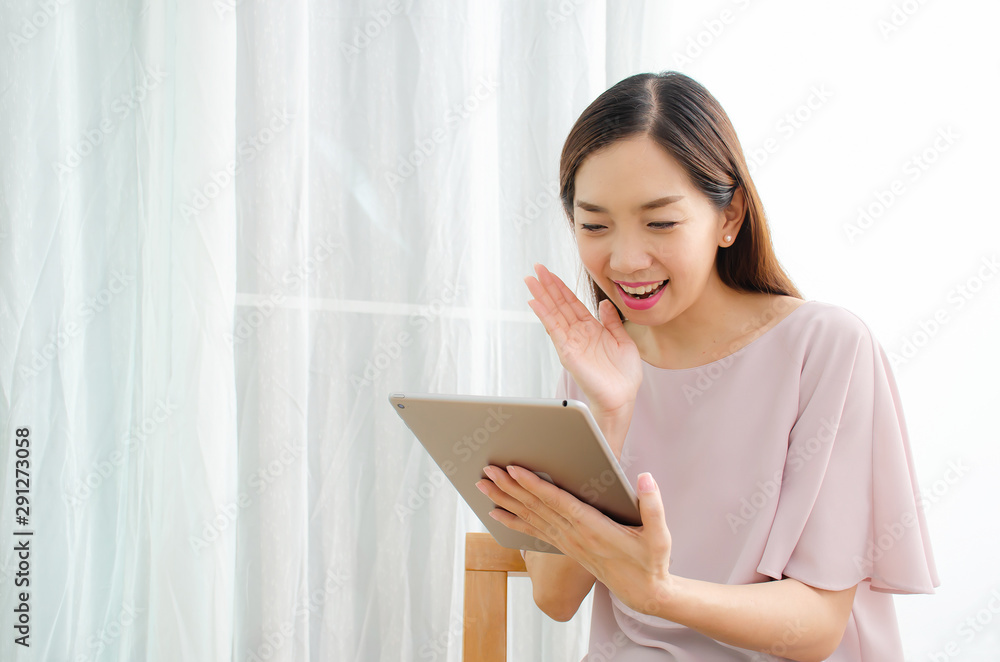 Happy young woman working and online shopping with tablet in home Happy young woman working and online shopping with tablet in home