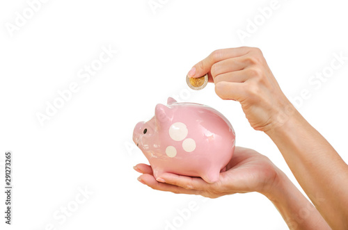 Woman hand putting money coin in to piggy for saving money wealth and financial concept, isolated on the white background