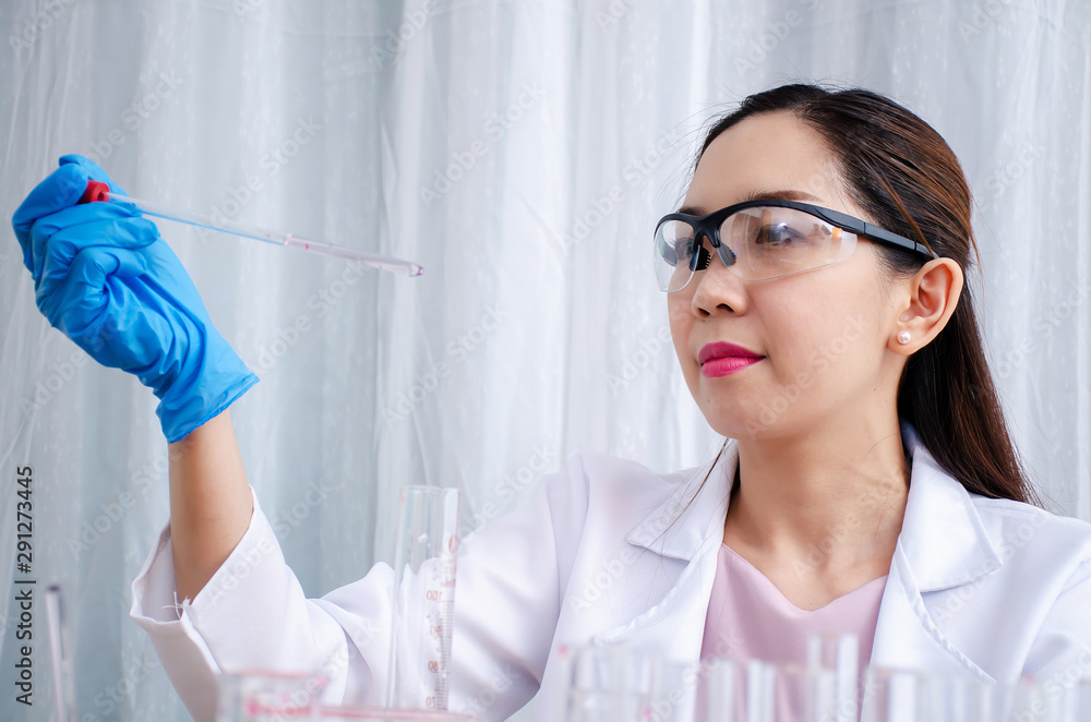 Scientist beautiful woman research and drop medical chemicals sample in test tube at laboratory, Science, chemistry, technology, biology concept Scientist beautiful woman research and drop medical chemicals sample in test tube at laboratory, Science, chemistry, technology, biology concept