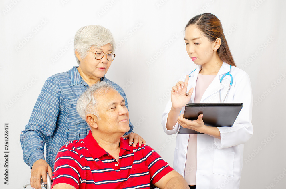 Asian woman Doctor talking to senior couple in wheelchair at hospital. Beautiful asian doctor taking care of patient in wheelchair, healthcare and medical concept . Asian woman Doctor talking to senior couple in wheelchair at hospital. Beautiful asian doctor taking care of patient in wheelchair, healthcare and medical concept .