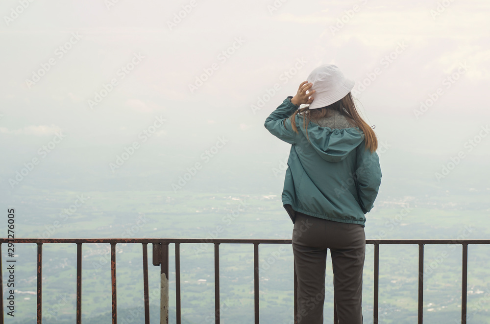 Women standing at balcony cliff looking view below mountain and hold a had at the same time Inhale fresh air Women standing at balcony cliff looking view below mountain and hold a had at the same time Inhale fresh air