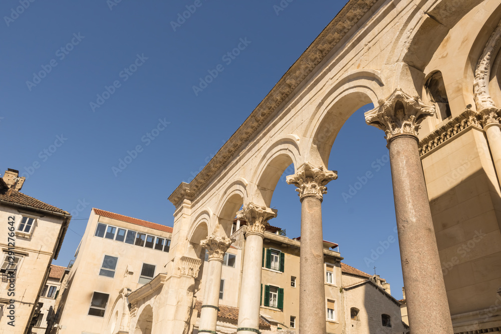 Beautiful roman columns near the entrance of Cathedral of Saint Domnius with the blue sky and houses, Split, Croatia - Image