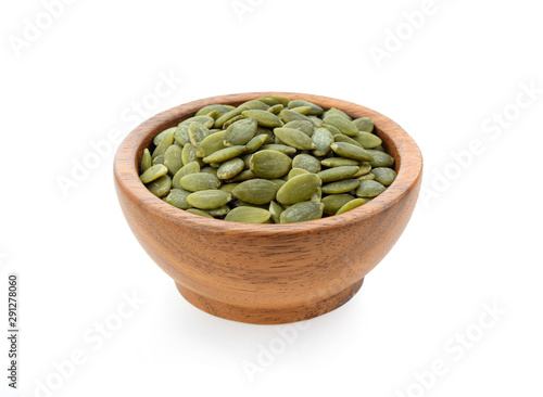Fotografi pumpkin seeds in wooden bowl isolated on white background