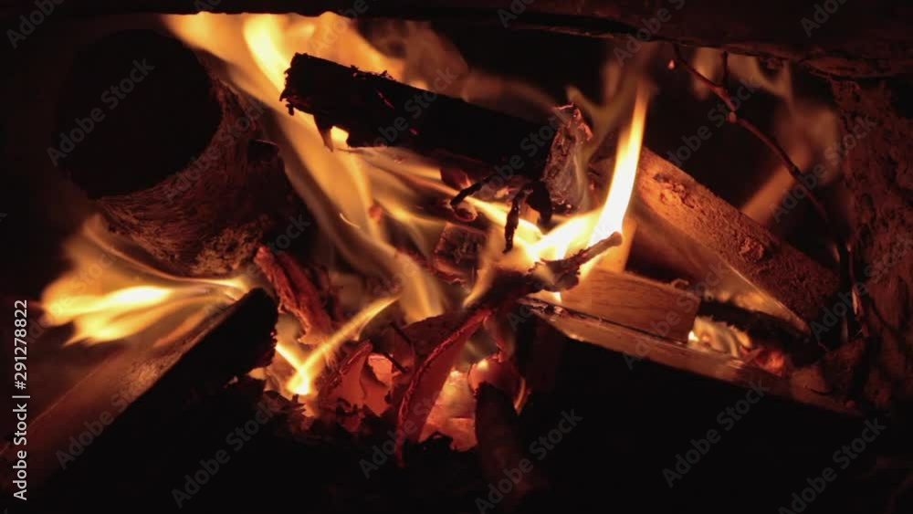 Shot close-up of a fire in a stove and fireplace. Burning firewood and paper from books and newspapers. House heating. Gas shutdown Shot close-up of a fire in a stove and fireplace. Burning firewood and paper from books and newspapers. House heating. Gas shutdown
