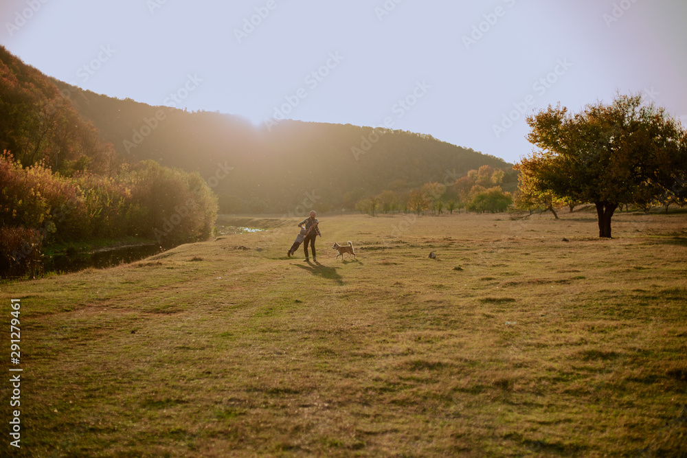 Fototapeta premium Amazing day for father and his son they playing with their beautiful husky dog in the middle of nature beside a lake
