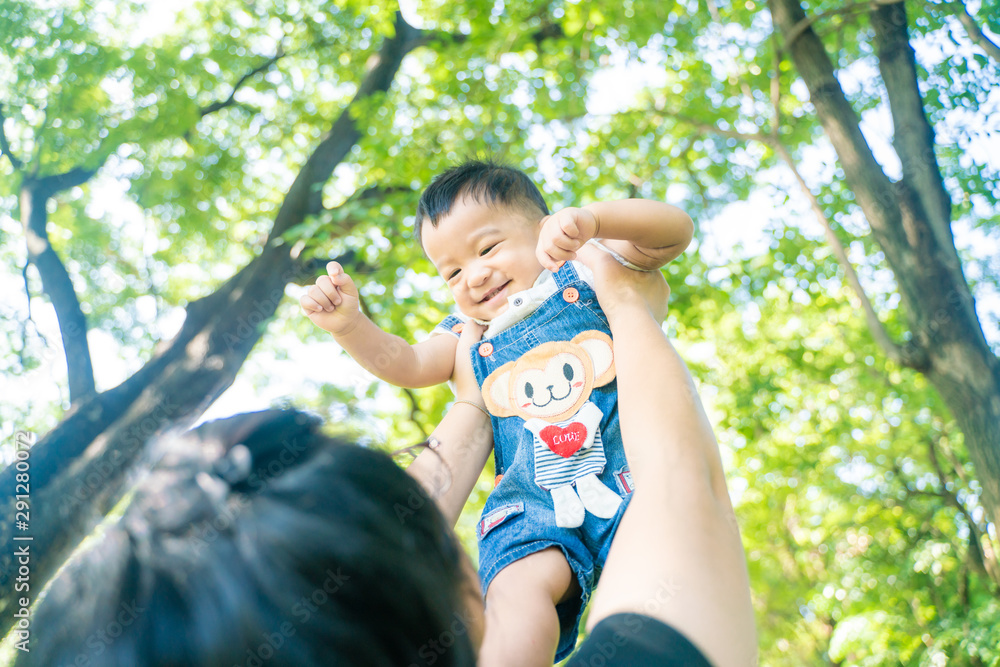 Happy laugh baby boy throw by mother hand Happy laugh baby boy throw by mother hand