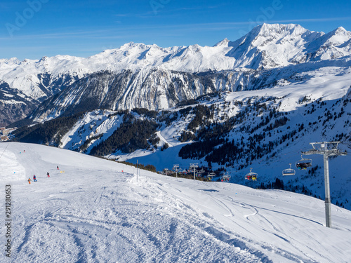 France, february 2019: Skiers on a piste at Courchevel ski resort, French Alps
