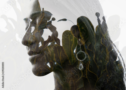 Double exposure of a young natural beauty's profile portrait combined with green and yellow leaves with healthy texture
