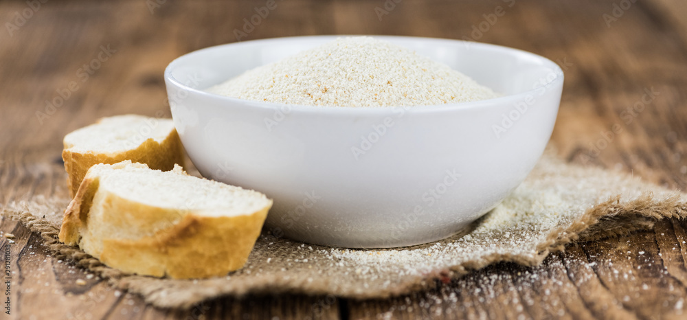 Some fresh Bread Crumbs on wooden background (selective focus; close-up shot) Some fresh Bread Crumbs on wooden background (selective focus; close-up shot)