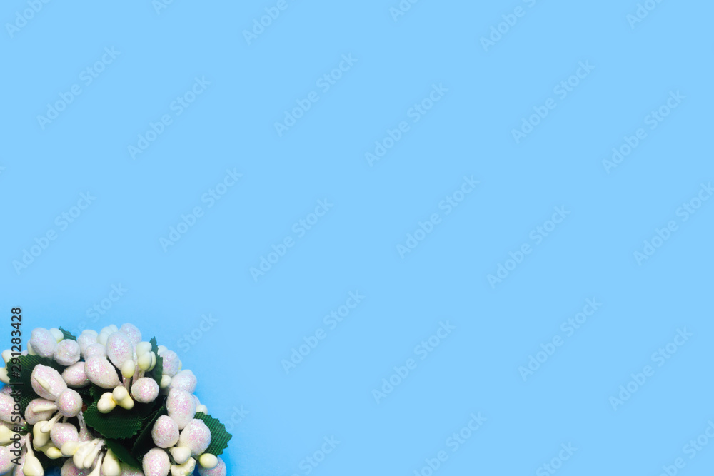 artificial roses on a blue background frame for text. copy space