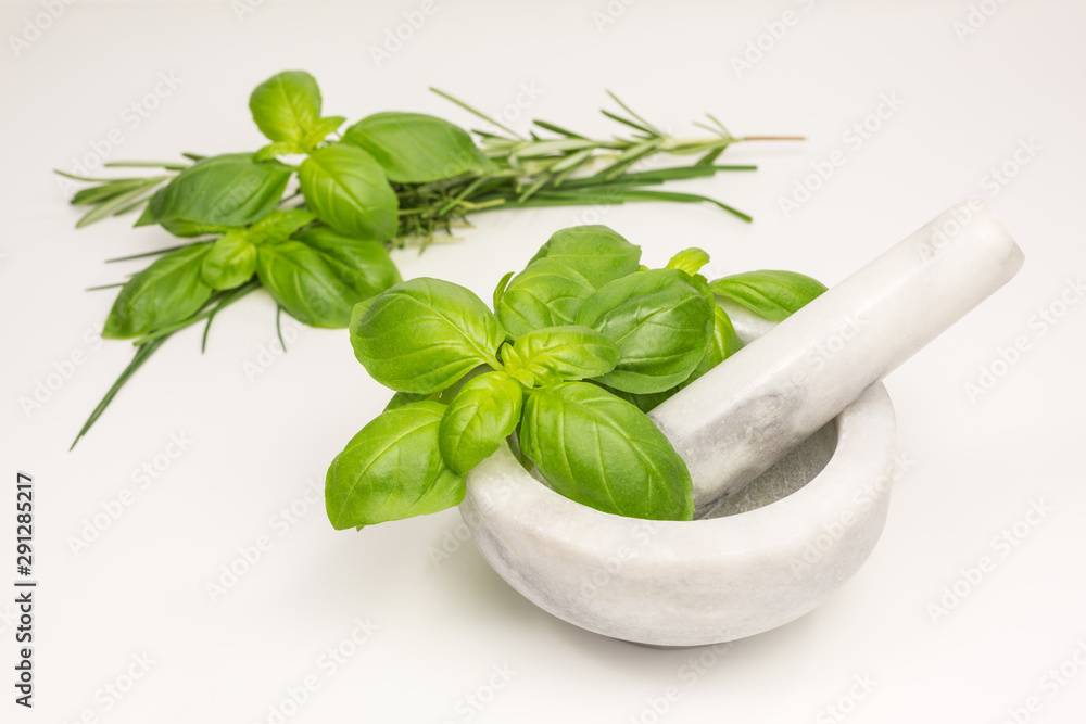 basil leaves with white and grey marble mortar and pestle