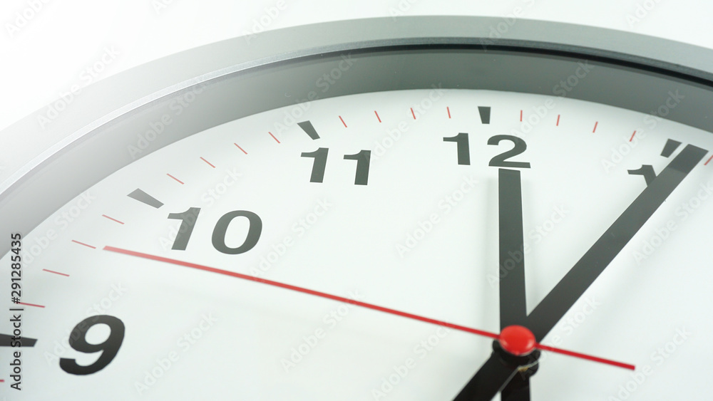 Gray wall clock face beginning of time 12.06 am or pm on White background, Copy space for your text, Time concept.. Gray wall clock face beginning of time 12.06 am or pm on White background, Copy space for your text, Time concept..
