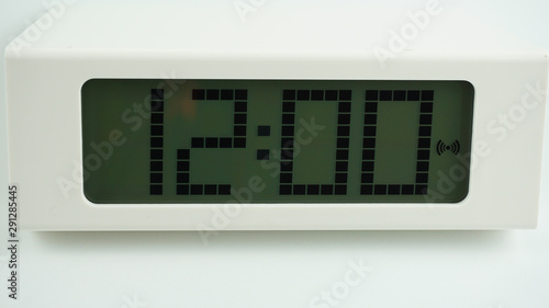 Digital alarm White clock time 12.00 am or pm on White background, Time concept..
