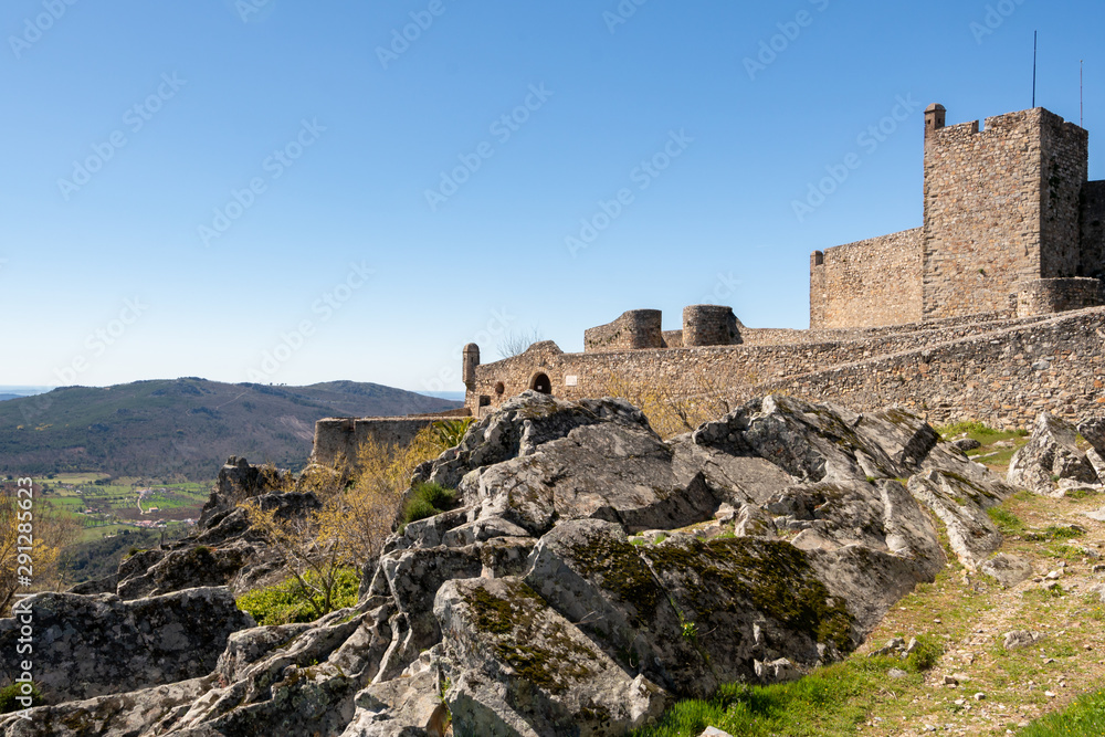 Marvao castle on the top of a mountain with beautiful green landscape behind on summer, in Portugal