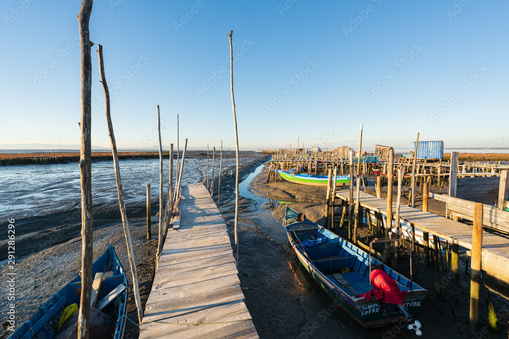 Fototapeta premium Carrasqueira Palafitic Pier in Comporta, Portugal with fishing boats