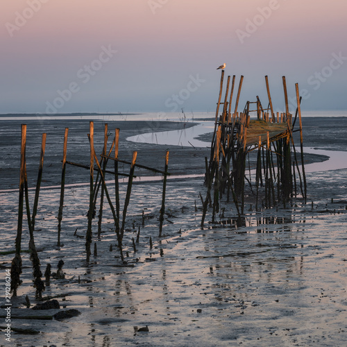 Carrasqueira Palafitic Pier in Comporta, Portugal at sunset photo