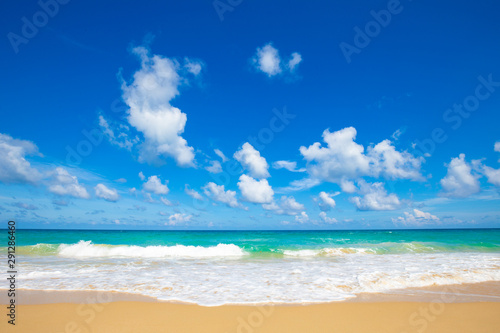 Sea wave on summer white beach with cloud sky