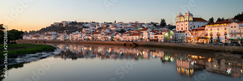 Panorama view of Alcacer do Sal cityscape from the other side of the Sado river at sunset
