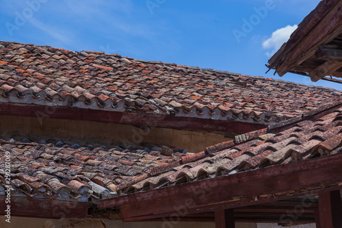 A tiled roof against a blue sky