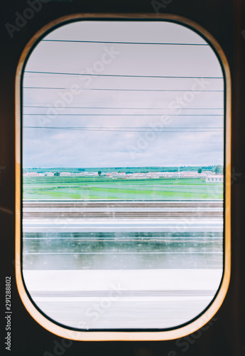 View from high speed train window in motion of countryside