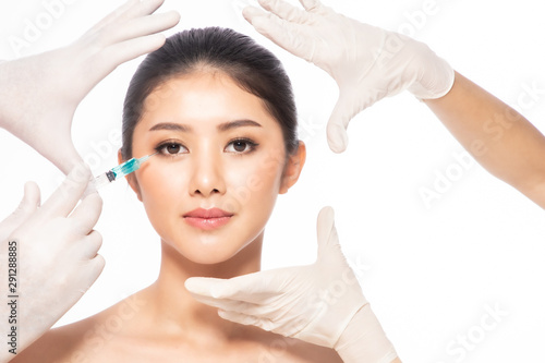 Asain young woman gets injection in her lips. Woman in beauty salon. plastic surgery clinic.Beautiful woman gets injection in her face.