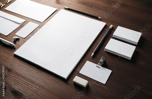 Photo of blank corporate stationery set on wood table background. Template for branding design.