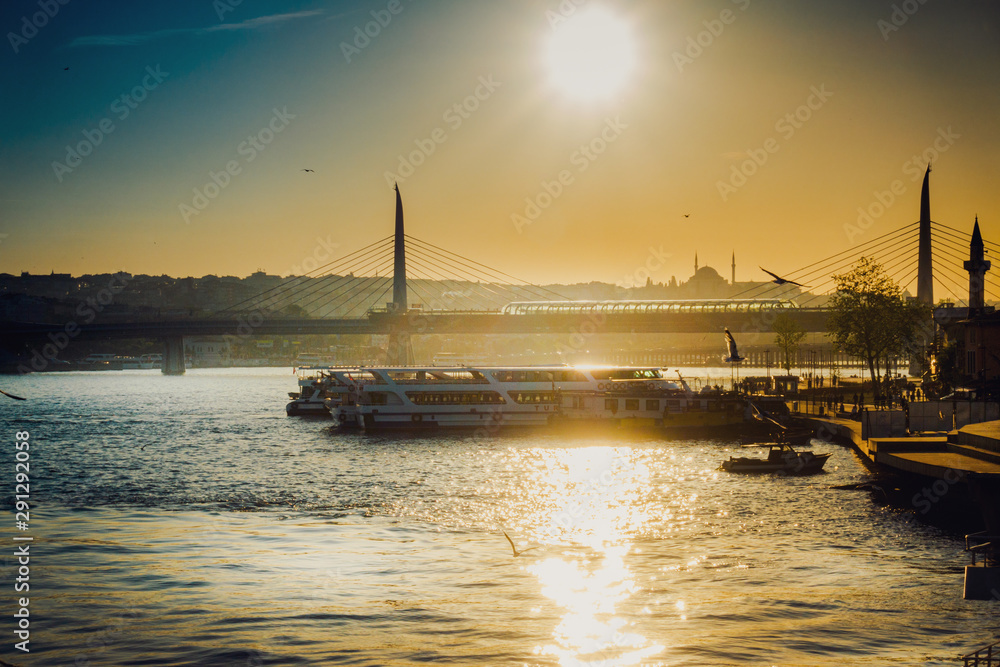 Naklejka premium View of ship at harbor with bridge in the background