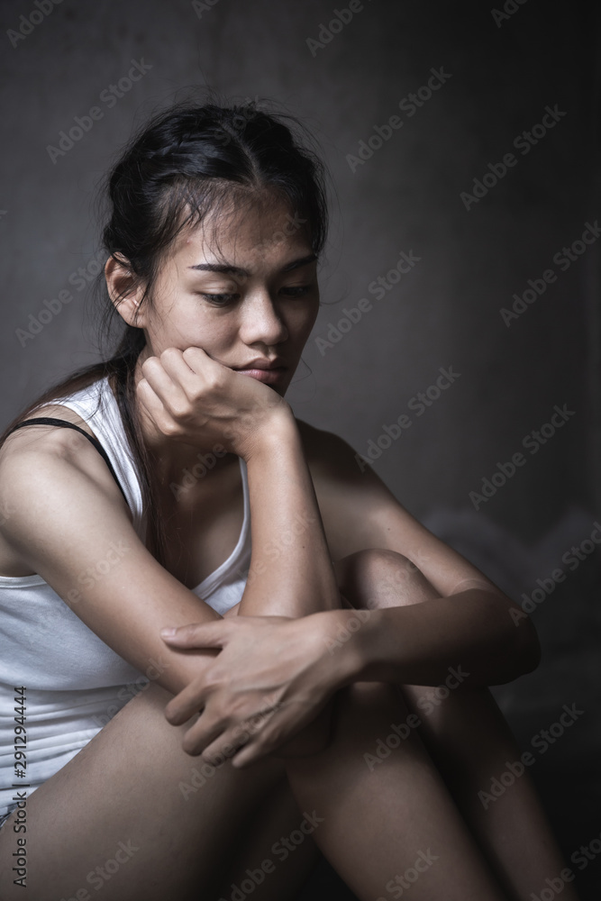  Women sitting on the floor crying with depression, Depressed woman sitting on ground, family problems, kitchen, abuse, Domestic violence, The concept of depression and suicide.