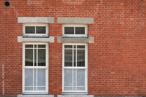 Traditional classic wood window and red brick wall in ancient house, city, japan