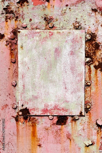 Rusty old plate on wall.