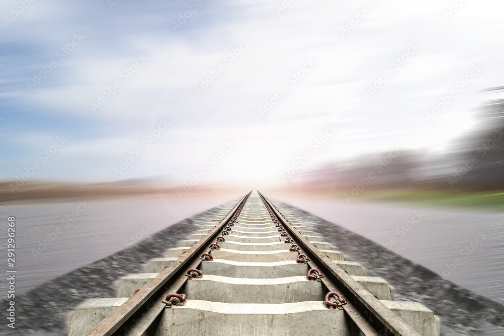 Train track with motion blur blue sky background. Feel like train is going to destination and finish to goal.