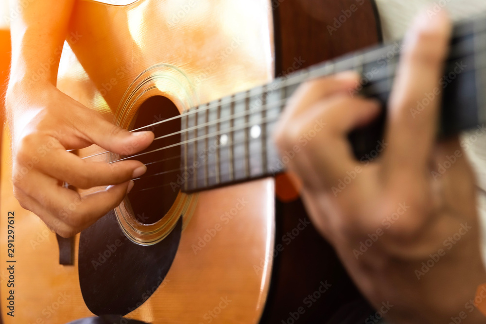 Fototapeta premium Close up of man hand playing acoustic guitar.