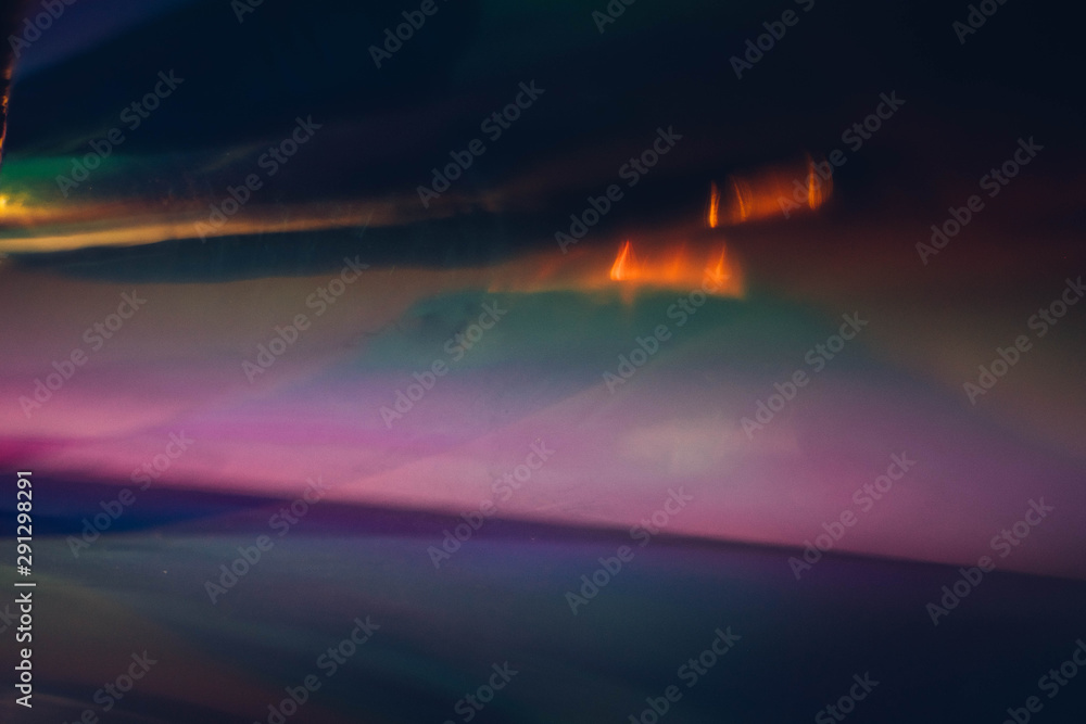 Blur multicolor glow. Lens flare light. Sunset landscape effect. Dark abstract background.