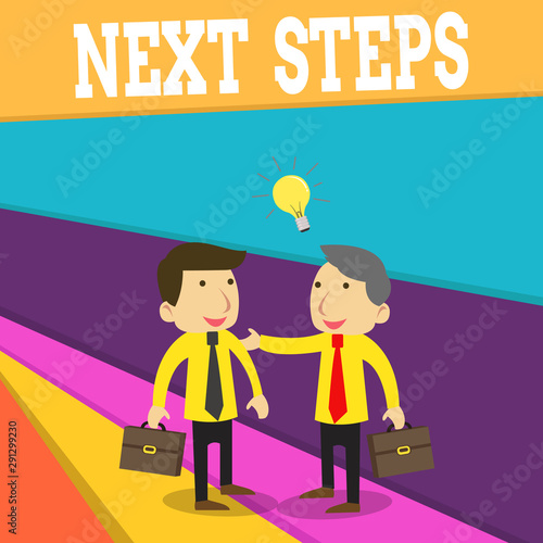 Word writing text Next Steps. Business photo showcasing something you do or plan after you ve finished something else Two White Businessmen Colleagues with Brief Cases Sharing Idea Solution