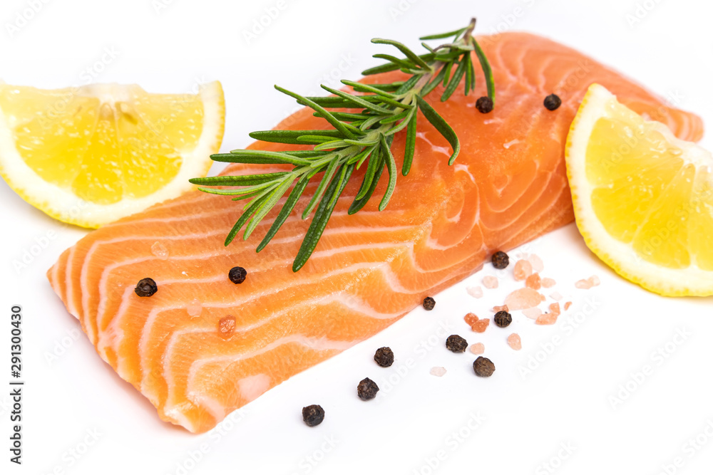 Fresh salmon steak with herbs and lemon isolated on white background Fresh salmon steak with herbs and lemon isolated on white background