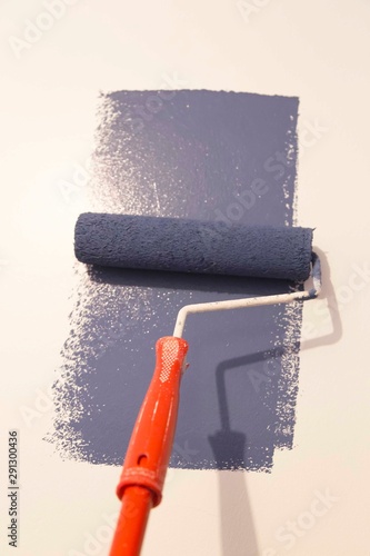 Decorator's hand painting wall with roller