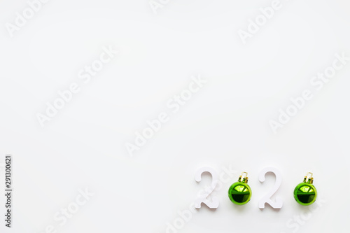 New Year 2020 background with bright green ball. White copy space. © Konstantin Aksenov