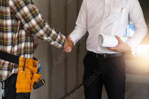 Close up engineer shaking hand with building contractor in construction site , successful negotiate of manager and industrial agreement cooperation concept