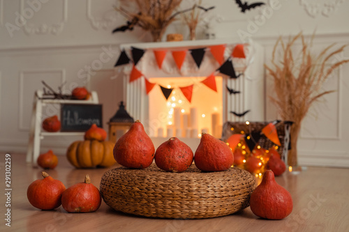 Halloween bright interior with pumpkins  wicker table with candles and fireplace