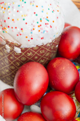 Easter spring cake with painted chicken eggs in a wicker basket