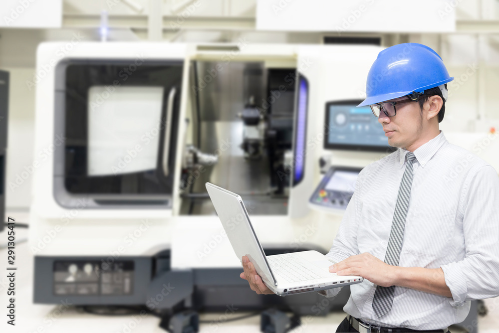 The engineer programming the robotic arms for loading the sheet metal to the hydraulic bending machine. The hi-technology in sheet metal working manufacturing process by autonomous robotic system. The engineer programming the robotic arms for loading the sheet metal to the hydraulic bending machine. The hi-technology in sheet metal working manufacturing process by autonomous robotic system.