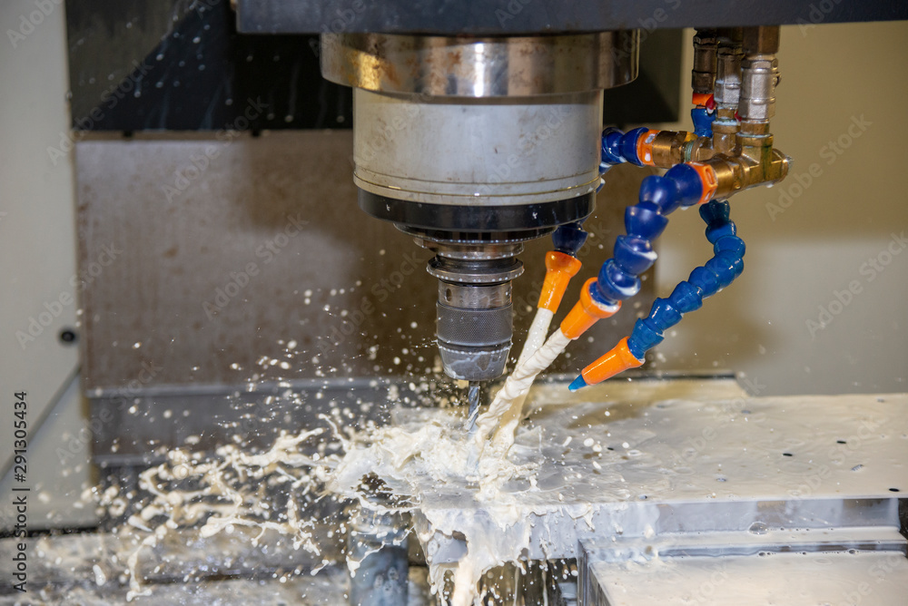 The CNC milling machine drilling the hole at mould base parts by